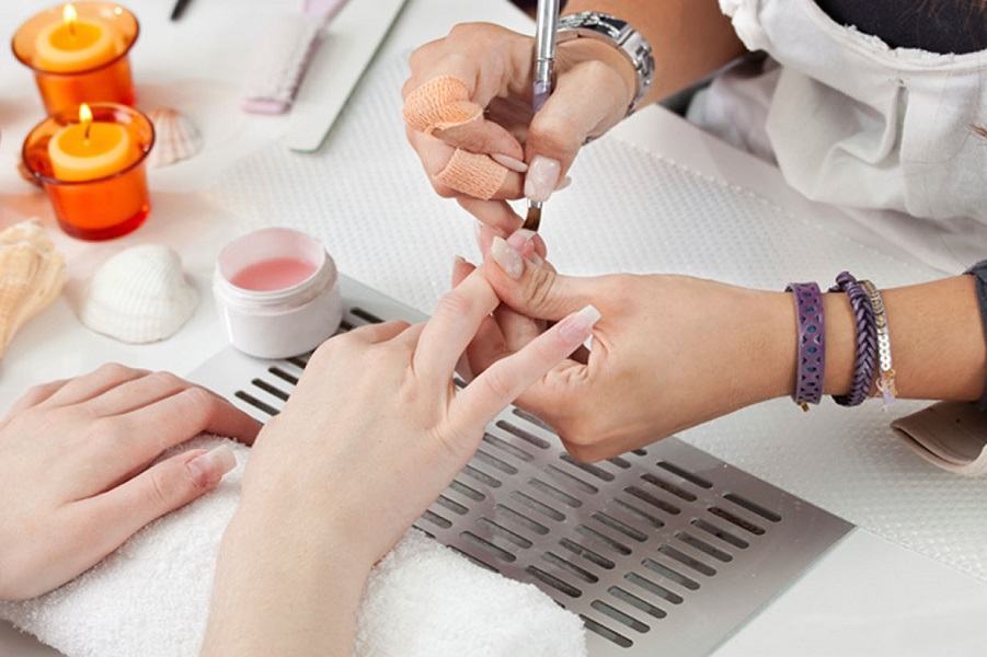 A person getting a manicure done with nail care